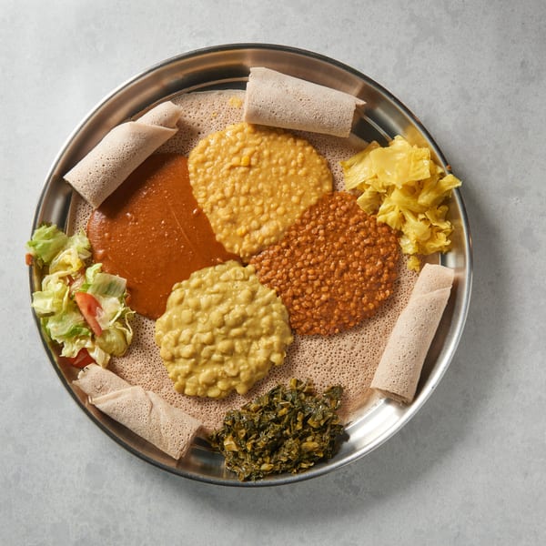 Altu's Ethiopian Cuisine platter with injera, various lentil stews, cabbage, and greens.