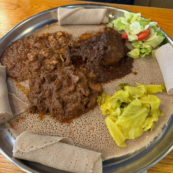 Altu's Ethiopian Cuisine platter with injera, two meat stews, cabbage, and a side salad.